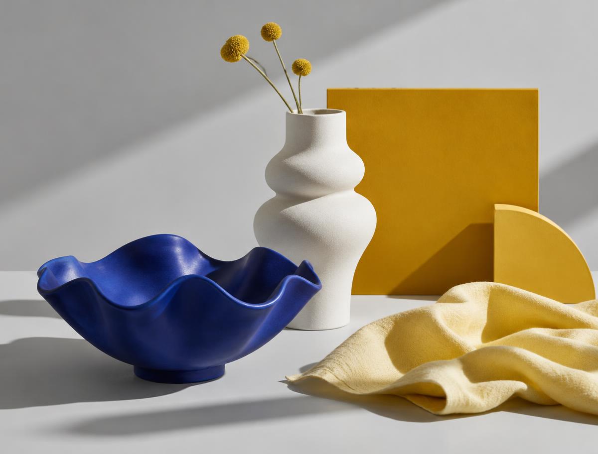 Blue ceramic homeware styled with gold and white accents